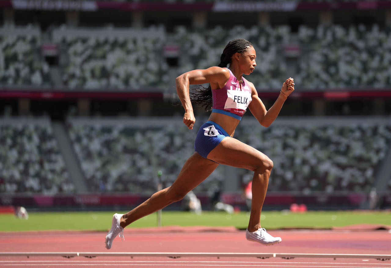 FILE - Allyson Felix, of United States races in a heat of the women's 400 meters at the 2020 Summer...