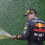 
              Red Bull driver Max Verstappen, of the Netherlands, celebrates on the podium after winning the Emilia Romagna Formula One Grand Prix, at the Enzo and Dino Ferrari racetrack, in Imola, Italy, Sunday, April 24, 2022. (AP Photo/Luca Bruno)
            