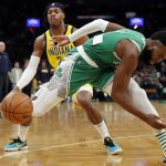 
              Boston Celtics' Jaylen Brown (7) loses control of the ball in front of Indiana Pacers' Buddy Hield during the first half of an NBA basketball game Friday, April 1, 2022, in Boston. (AP Photo/Michael Dwyer)
            