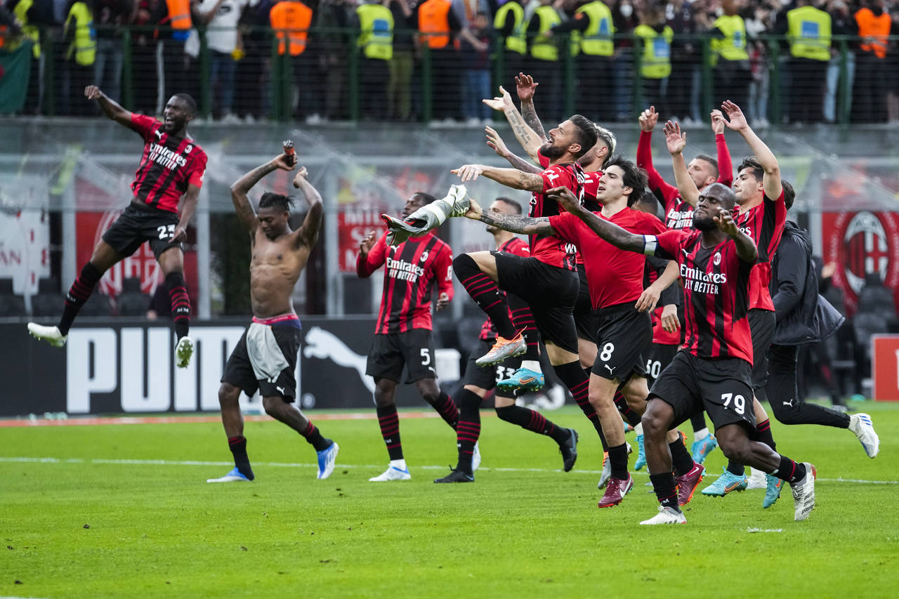 AC Milan players celebrate at the end of the Serie A soccer match between AC Milan and Genoa, at th...