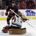 
              Minnesota Wild goaltender Marc-Andre Fleury (29) deflects a Carolina Hurricanes shot with Hurricanes' Max Domi (13) nearby during the second period of an NHL hockey game in Raleigh, N.C., Saturday, April 2, 2022. (AP Photo/Karl B DeBlaker)
            