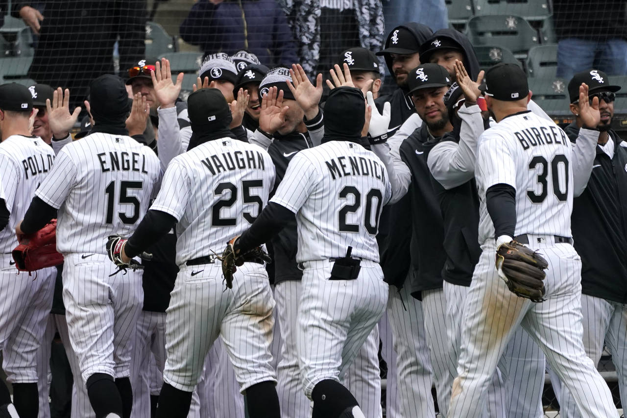 The Chicago White Sox celebrate the team's 7-3 win over the Kansas City Royals after a baseball gam...