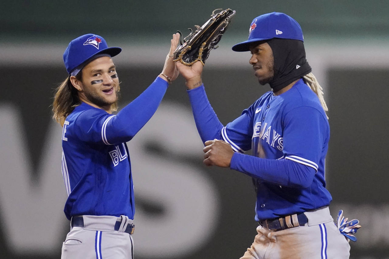 Toronto Blue Jays' Raimel Tapia, right, celebrates with Bo Bichette after the Blue Jays defeated th...
