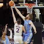 
              North Carolina forward Brady Manek blocks a shoot by Kansas guard Christian Braun during the first half of a college basketball game in the finals of the Men's Final Four NCAA tournament, Monday, April 4, 2022, in New Orleans. (AP Photo/David J. Phillip)
            