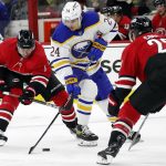 
              Buffalo Sabres' Dylan Cozens (24) maintains control of the puck between Carolina Hurricanes' Brendan Smith (7) and Ian Cole (28) during the first period of an NHL hockey game in Raleigh, N.C., Thursday, April 7, 2022. (AP Photo/Karl B DeBlaker)
            