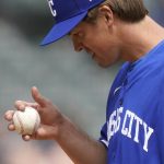 
              Kansas City Royals starting pitcher Zack Greinke looks at a baseball during the team's game against the Chicago White Sox on Wednesday, April 27, 2022, in Chicago. (AP Photo/Charles Rex Arbogast)
            