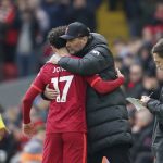 
              Liverpool's Curtis Jones, left, embraces his coach Jurgen Klopp as he leaves the field during the English Premier League soccer match between Liverpool and Watford at Anfield stadium in Liverpool, England, Saturday, April 2, 2022. (AP Photo/Jon Super)
            