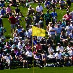 
              Spectators wait for play on the 15th green during a practice round for the Masters golf tournament on Monday, April 4, 2022, in Augusta, Ga. (AP Photo/Matt Slocum)
            