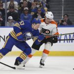 
              Buffalo Sabres left wing Jeff Skinner (53) and Philadelphia Flyers left wing Oskar Lindblom (23) battle for possession of the puck during the first period of an NHL hockey game on Saturday, April. 16, 2022, in Buffalo, N.Y. (AP Photo/Joshua Bessex)
            