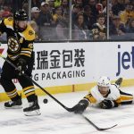 
              Pittsburgh Penguins defenseman Mike Matheson deflects a pass by Boston Bruins' Brad Marchand during the second period of an NHL hockey game Saturday, April 16, 2022, in Boston. (AP Photo/Winslow Townson)
            