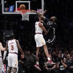 
              Brooklyn Nets' Andre Drummond, right, tries to dunk over Cleveland Cavaliers' Evan Mobley during the first half of the opening basketball game of the NBA play-in tournament Tuesday, April 12, 2022, in New York. (AP Photo/Seth Wenig)
            