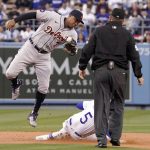 
              Los Angeles Dodgers' Freddie Freeman, center, steals second as Detroit Tigers second baseman Jonathan Schoop, left, takes a high throw from home during the first inning of a baseball game Friday, April 29, 2022, in Los Angeles. (AP Photo/Mark J. Terrill)
            