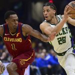 
              Milwaukee Bucks guard Lindell Wigginton drives on Cleveland Cavaliers guard Rajon Rondo in the first half of an NBA basketball game, Sunday, April 10, 2022, in Cleveland. (AP Photo/David Dermer)
            