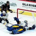 
              St. Louis Blues goaltender Jordan Binnington, right, looks for the puck after making a save on a shot by Arizona Coyotes left wing Loui Eriksson (21) as Blues left wing Nathan Walker (26) skates to the puck during the first period of an NHL hockey game Saturday, April 23, 2022, in Glendale, Ariz. (AP Photo/Ross D. Franklin)
            