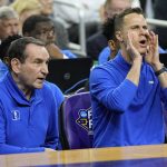 
              FILE - Duke head coach Mike Krzyzewski, left, looks on as assistant coach Jon Scheyer yells during the first half of a college basketball game against North Carolina in the semifinal round of the men's Final Four NCAA tournament, Saturday, April 2, 2022, in New Orleans. Krzyzewski is one of three Hall of Fame coaches to leave the college game in roughly 13 months while Scheyer has taken over as a first-year head coach. (AP Photo/David J. Phillip, File)
            