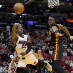 
              Miami Heat forward Jimmy Butler (22) passes the bal as Atlanta Hawks forward Onyeka Okongwu defends during the second half of an NBA basketball game Friday, April 8, 2022, in Miami. The Heat won 113-109. (AP Photo/Lynne Sladky)
            