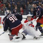 
              Montreal Canadiens' Brendan Gallagher, center, collides with Columbus Blue Jackets' Elvis Merzlikins, left, as Andrew Peeke skates past during the third period of an NHL hockey game Wednesday, April 13, 2022, in Columbus, Ohio. (AP Photo/Jay LaPrete)
            
