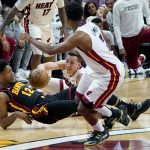 
              Atlanta Hawks forward De'Andre Hunter (12) and Miami Heat guard Duncan Robinson go for a loose ball during the first half of Game 1 of an NBA basketball first-round playoff series, Sunday, April 17, 2022, in Miami. (AP Photo/Lynne Sladky)
            