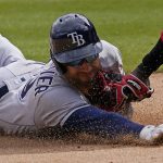 
              Tampa Bay Rays' Kevin Kiermaier, left, is tagged out by Chicago White Sox third baseman Josh Harrison during the ninth inning of a baseball game in Chicago, Saturday, April 16, 2022. (AP Photo/Nam Y. Huh)
            