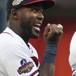 
              Atlanta Braves center fielder Guillermo Heredia shows off his World Series ring during a ceremony before the team's baseball game against the Cincinnati Reds on Saturday, April 9, 2022, in Atlanta. (AP Photo/John Bazemore)
            