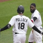 
              Chicago White Sox's AJ Pollock (18) greets teammate Josh Harrison after Harrison scored on his sacrifice fly during the eighth inning of a baseball game against the Kansas City Royals, Thursday, April 28, 2022, in Chicago. (AP Photo/Charles Rex Arbogast)
            