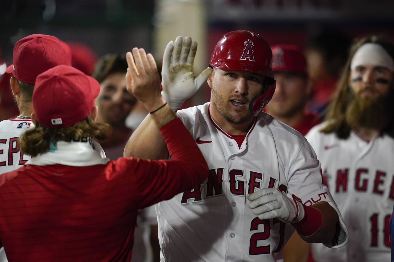 Los Angeles Angels center fielder Mike Trout (27) celebrates in the dugout after hitting a homerun ...