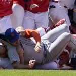 
              New York Mets' Pete Alonso is taken to the ground by St. Louis Cardinals first base coach Stubby Clapp, rear, as benches clear during a scuffle in the eighth inning of a baseball game Wednesday, April 27, 2022, in St. Louis. Clapp was ejected from the game. (AP Photo/Jeff Roberson)
            