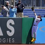 
              Pittsburgh Pirates right fielder Ben Gamel (18) loses his glove as he leaps, but can't reach, a solo home run hit by Milwaukee Brewers' Andrew McCutchen to lead off the first inning of a baseball game in Pittsburgh, Thursday, April 28, 2022. (AP Photo/Gene J. Puskar)
            