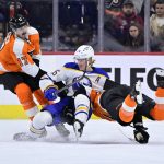 
              Buffalo Sabres' Rasmus Dahlin, center, and Philadelphia Flyers' Egor Zamula, right, collide in front of Zack MacEwen (17) during the second period of an NHL hockey game, Sunday, April 17, 2022, in Philadelphia. (AP Photo/Derik Hamilton)
            