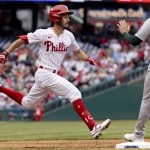 
              Philadelphia Phillies' Garrett Stubbs (21) is safe at first on a bunt as Oakland Athletics first baseman Seth Brown (15) waits for the throw during the third inning of a baseball game, Sunday, April 10, 2022, in Philadelphia. (AP Photo/Laurence Kesterson)
            