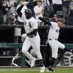 
              Chicago White Sox's Luis Robert, left, celebrates with third base coach Joe McEwing after hitting a solo home run against the Seattle Mariners during the sixth inning of a baseball game in Chicago, Tuesday, April 12, 2022. (AP Photo/Nam Y. Huh)
            