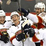 
              Florida Panthers defenseman Gustav Forsling (42) celebrates his goal with Brandon Montour (62) and Aleksander Barkov (16) during the overtime period of an NHL hockey game against the New Jersey Devils Saturday, April 2, 2022, in Newark, N.J. The Panthers won 7-6 in overtime. (AP Photo/Bill Kostroun)
            