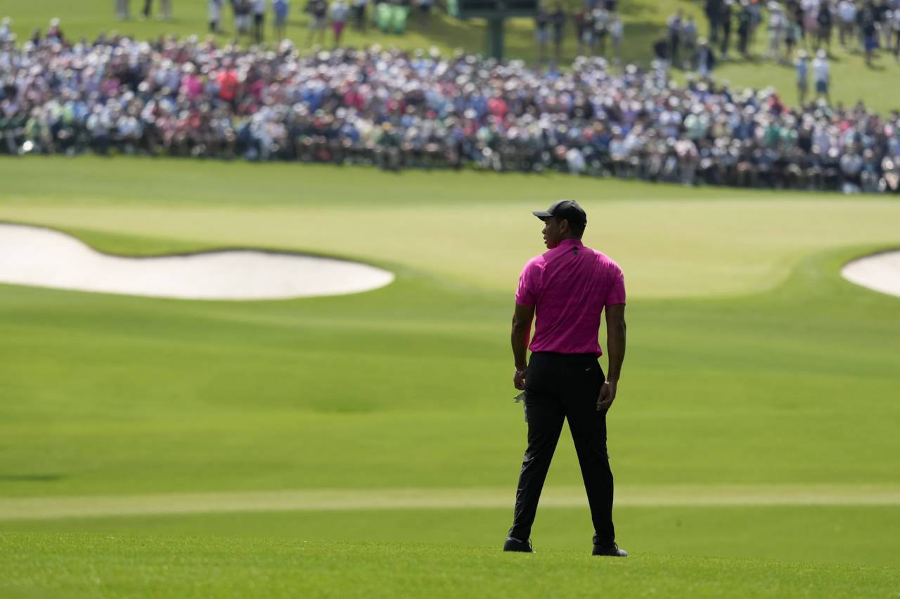 Tiger Woods waits to play on the second fairway during the first round at the Masters golf tourname...