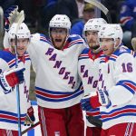 
              New York Rangers' Andrew Copp (18) celebrates with Adam Fox (23), Ryan Lindgren (55) and Ryan Strome (16) after scoring a goal during the first period of the team's NHL hockey game against the New York Islanders on Thursday, April 21, 2022, in Elmont, N.Y. (AP Photo/Frank Franklin II)
            