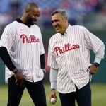 
              Villanova's Jay Wright, right, and Kyle Neptune smile before throwing out ceremonial pitches before a baseball game between the Philadelphia Phillies and the Milwaukee Brewers, Sunday, April 24, 2022, in Philadelphia. (AP Photo/Matt Slocum)
            