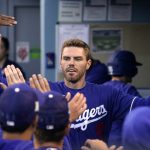 
              Los Angeles Dodgers' Freddie Freeman is congratulated by teammates in the dugout after scoring on a double by Trea Turner during the first inning of a spring training baseball game against the Los Angeles Angels Tuesday, April 5, 2022, in Los Angeles. (AP Photo/Mark J. Terrill)
            