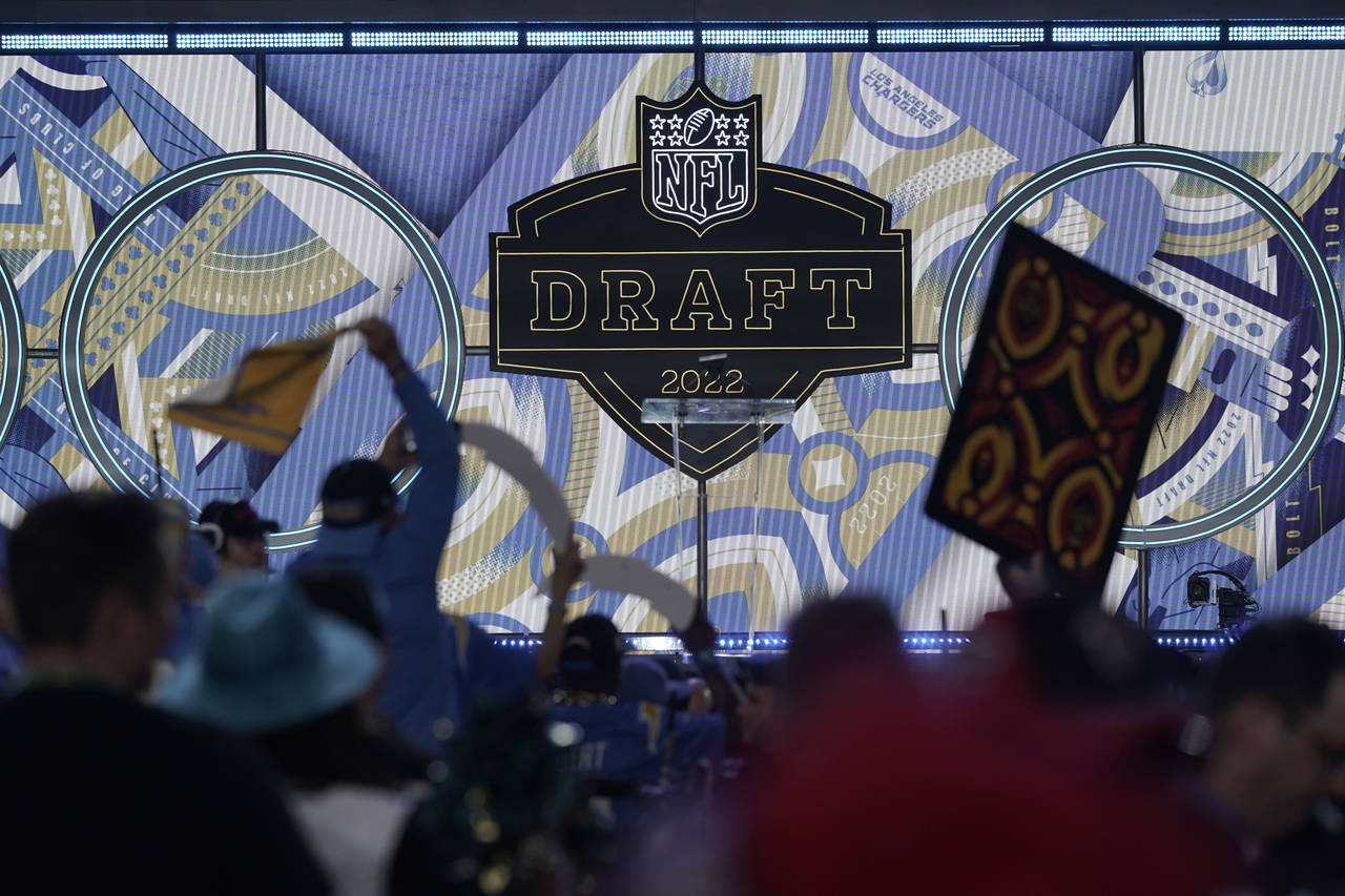 Fans cheer during the third round of the NFL football draft Friday, April 29, 2022, in Las Vegas. (...