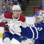 
              Toronto Maple Leafs goaltender Erik Kallgren (50) makes a save as Montreal Canadiens center Rem Pitlick (32) looks for a rebound during the first period of an NHL hockey action in Toronto, Saturday, April 9, 2022. (Frank Gunn/The Canadian Press via AP)
            
