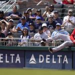 
              Washington Nationals left fielder Juan Soto (22) hits the wall in an attempt to catch a foul ball hit by Atlanta Braves' Alex Dickerson (25) during the fourth inning of a baseball game Wednesday, April 13, 2022, in Atlanta. (AP Photo/Brynn Anderson)
            