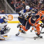 
              St. Louis Blues goalie Ville Husso (35) looks for the shot as Edmonton Oilers' Jesse Puljujarvi (13) and Ryan O'Reilly (90) work in front during the second period of an NHL hockey game Friday, April 1, 2022, in Edmonton, Alberta. (Jason Franson/The Canadian Press via AP)
            