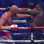 
              Britain's Tyson Fury, left, lands a blow on Britain's Dillian Whyte during their WBC heavyweight title boxing fight at Wembley Stadium in London, Saturday, April 23, 2022. (AP Photo/Ian Walton)
            