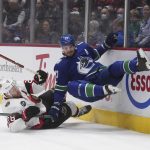 
              Ottawa Senators' Connor Brown, left, and Vancouver Canucks' Oliver Ekman-Larsson collide during the first period of an NHL hockey game Tuesday, April 19, 2022, in Vancouver, British Columbia. (Darryl Dyck/The Canadian Press via AP)
            