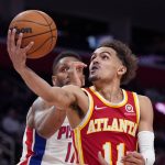 
              FILE - Atlanta Hawks guard Trae Young (11) makes a layup as Detroit Pistons guard Rodney McGruder defends during the second half of an NBA basketball game, Wednesday, March 23, 2022, in Detroit. (AP Photo/Carlos Osorio, File)
            