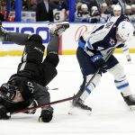 
              Winnipeg Jets defenseman Neal Pionk (4) send Tampa Bay Lightning left wing Brandon Hagel (38) flying with a check during the second period of an NHL hockey game Saturday, April 16, 2022, in Tampa, Fla. (AP Photo/Chris O'Meara)
            