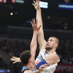 
              Los Angeles Clippers center Ivica Zubac, right, shoots as Oklahoma City Thunder forward Isaiah Roby defends during the first half of an NBA basketball game Sunday, April 10, 2022, in Los Angeles. (AP Photo/Mark J. Terrill)
            