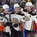 
              Anaheim Ducks center Trevor Zegras (46) celebrates with defensemen Jamie Drysdale (34) and Cam Fowler (4) after scoring a goal against the Arizona Coyotes during the first period of an NHL hockey game Friday, April 1, 2022, in Glendale, Ariz. (AP Photo/Rick Scuteri)
            