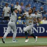 
              Oakland Athletics Cristian Pache runs home to score past third base coach Darren Bush against the Tampa Bay Rays during the second inning of a baseball game Thursday, April, 14, 2022, in St. Petersburg, Fla. (AP Photo/Scott Audette)
            