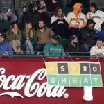 
              Seattle Mariners fans sit near a sign, based on the popular Wordle game, that refers to the Houston Astros cheating scandal, during a baseball game Friday, April 15, 2022, in Seattle. (AP Photo/Ted S. Warren)
            