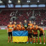 
              Players of Shakhtar Donetsk hold a Ukranian flag as they pose for a photo ahead of a friendly charity soccer match against Olympiakos at Karaiskaki stadium in Piraeus, near Athens, on Saturday, April 9, 2022. Ukrainian soccer club Shakhtar Donetsk will play a series of charity games on a government-backed “Global Tour for Peace” that will raise money for the country’s military in the war against Russia. The tour starts Saturday against Greek league leader Olympiakos. (AP Photo/Yorgos Karahalis)
            