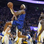 
              Denver Nuggets forward Will Barton, top, shoots against Golden State Warriors forward Draymond Green during the first half of Game 2 of an NBA basketball first-round playoff series in San Francisco, Monday, April 18, 2022. (AP Photo/Jeff Chiu)
            
